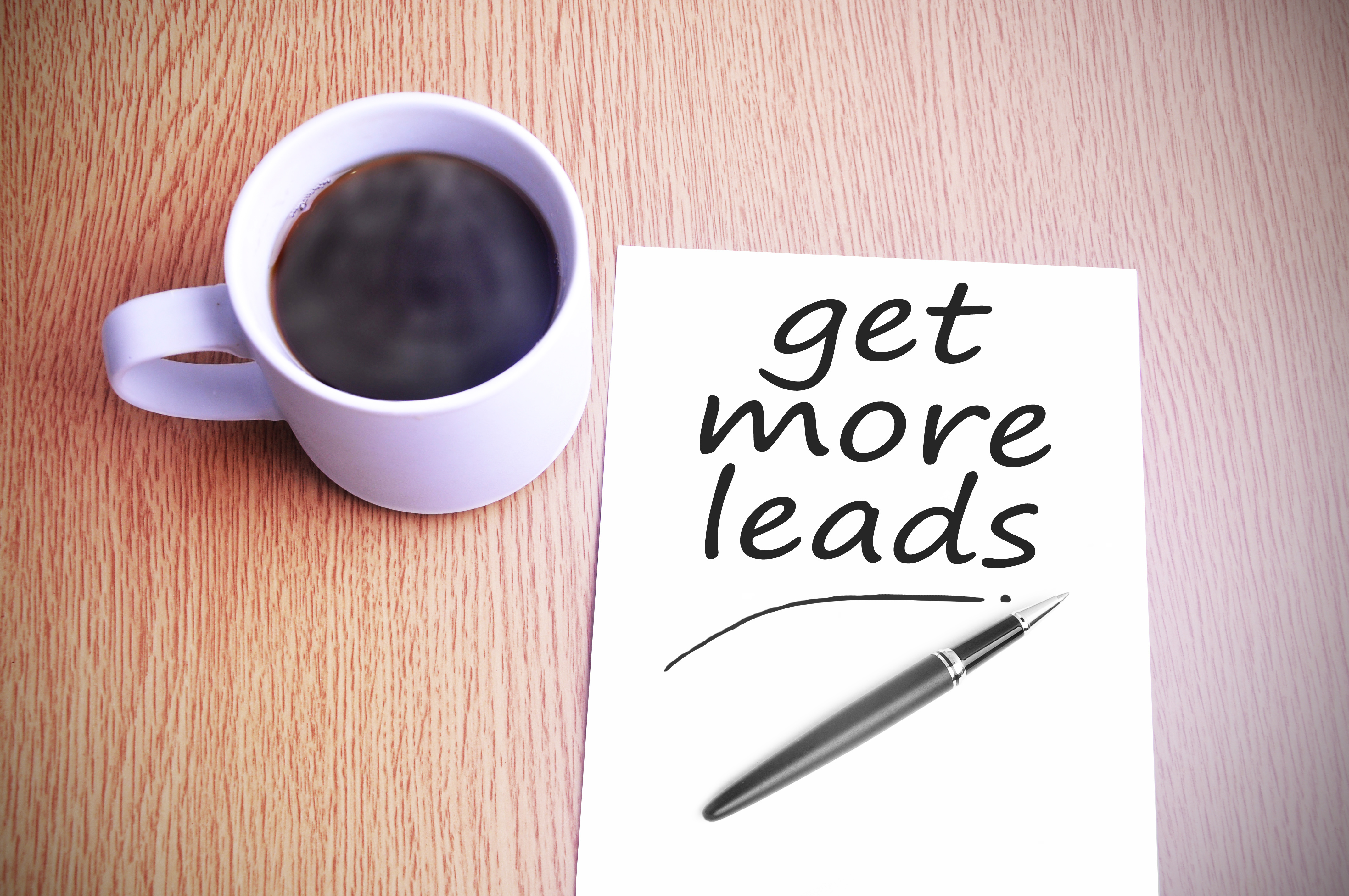 Black coffee on the table with note writing get more leads